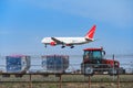 Sheremetyevo, Aircraft of the Russian Airlines `Royal Flight` prepare to landing above the mini tractor of equipment service of