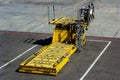 SHEREMETYEVO, MOSCOW REGION, RUSSIA - APRIL 28, 2019: Yellow cargo equipment car loader for luggage in the airport hub