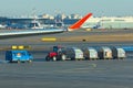 Sheremetyevo, Moscow, Russia. 12/04/2019. Ground service personnel. Unfocused tractor and luggage carts traveling at the airport.