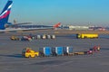 Sheremetyevo, Moscow, Russia. 12/04/2019. Ground service. Unfocused luggage carts, tanker and others, traveling ontu the airport.