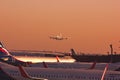 Sheremetyevo, Moscow, Russia. 12/04/2019. Sunset over airport. Silhouette of an airplane lands over of parts of other planes.