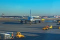 Sheremetyevo, Moscow, Russia. 12/04/2019. Unfocused Plane rides on the runway. Ground service personnel are waiting for it.