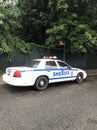 Sheriff car parked on the side of the street with NO PARKING sign