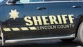 Sheriff name on side of Lincoln County vehicle with badge