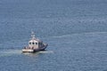 Sheriffs Boat Pulling Away in Blue Water Royalty Free Stock Photo