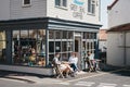 People at the outside tables of Grey Seal Coffee shop in Sheringham, Norfolk, UK