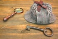 Sherlock Holmes Cap famous as Deerstalker, Old Key and Magnifier Royalty Free Stock Photo