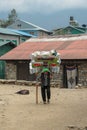 Sherpa porter carrying a heavy load in Nepal