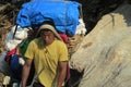 Sherpa porter carry basket in Nepal trekking path