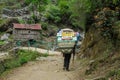 Sherpa porter carry basket in Nepal trekking path