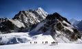 Sherpas crossing an Himalayam glacier Royalty Free Stock Photo