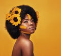 Shes beautiful beyond words. Studio shot of a beautiful young woman posing topless with sunflowers in her hair against a Royalty Free Stock Photo