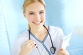 Shes the best medical intern here. Portrait of a pretty nurse with her stethoscope holding a medical file with copyspace Royalty Free Stock Photo