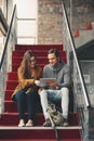 Shes the best study buddy around. Full length shot of two young university students studying while sitting on a Royalty Free Stock Photo