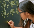 Shes a child genius. a little girl writing maths equations on a blackboard. Royalty Free Stock Photo