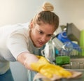 Shes a cleaning whizz. a young woman cleaning her kitchen at home.