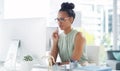 Shes coming up with a master plan. an attractive young businesswoman looking thoughtful working at her desk in a modern