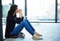 Shes cracking under the pressure. a stressed businesswoman sitting on the floor outside the boardroom.