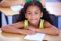 Shes a diligent student. Portrait of a little girl sitting in her desk in the classroom.