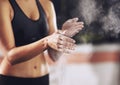 Shes fighting fit. a woman coating her hands with sports chalk before a workout.