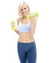 Shes focused on optimum fitness. Sporty young woman lifting dumbbells while isolated on white. Royalty Free Stock Photo