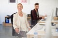 Shes found the right career space for her. Portrait of a smiling businesswoman sitting at her desk with her colleague in Royalty Free Stock Photo