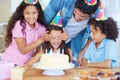 Shes getting a birthday surprise. a girl covering her friends eyes at her birthday party. Royalty Free Stock Photo