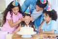 Shes getting a birthday surprise. a girl covering her friends eyes at her birthday party. Royalty Free Stock Photo