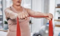 Shes getting stronger with every stretch. an unrecognizable woman exercising with a resistance band during her