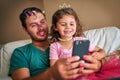 Shes given Dad a real makeover. a father and his little daughter taking a selfie together while playing dress-up at home