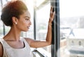 Shes a go-getter. an ambitious young businesswoman looking through her office window.