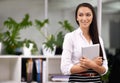 Shes going places. an attractive young woman holding a digital tablet in the office. Royalty Free Stock Photo