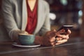 Shes got all the connections. an unidentifiable woman texting on a cellphone in a cafe. Royalty Free Stock Photo