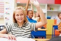 Shes got the answer. Sweet young girl raising her hand in class to answer a question - copyspace. Royalty Free Stock Photo