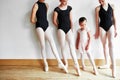 Shes got big ballet shoes to fill. a group of young ballerinas teaching a little girl ballet in a dance studio. Royalty Free Stock Photo