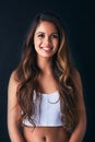 Shes got a bubbly personality. Studio portrait of an attractive young woman posing against a dark background. Royalty Free Stock Photo