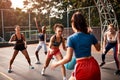 Shes almost got it. a diverse group of sportswomen playing a competitive game of basketball together during the day.