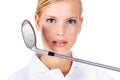 Shes got a great game. Closeup portrait of a young golfer holding her club near her face isolated on white.