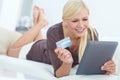 Shes got her credit card ready. a beautiful woman doing some online shopping at home using her digital tablet. Royalty Free Stock Photo