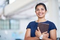 Shes got her entire day planned out. Shot of an attractive young businesswoman holding her journal while standing in an