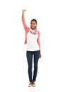 Shes got it in her reach. A full body portrait of a pretty young woman posing with one arm raised against a white