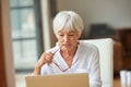 Shes got some decisions to make. a senior woman using a laptop.