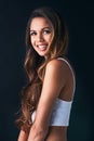 Shes got such a charming smile. Studio portrait of an attractive young woman posing against a dark background. Royalty Free Stock Photo