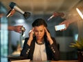 Shes got too many demands and distractions to deal with. a stressed out businesswoman working late in an office. Royalty Free Stock Photo