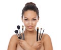 Shes got the whole set. Beauty portrait of a young woman holding up make-up brushes.