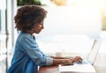 Shes always hard at work. an attractive young woman working on her laptop at home. Royalty Free Stock Photo