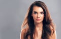 Shes having a sublime hair day. Studio shot of a beautiful young woman posing against a gray background.