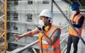 Shes just raised the bar in urban development. a young woman using a walkie talkie while working with her colleague at a