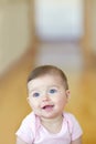 Shes just too cute. Portrait of an adorable baby girl sitting on the living room floor.