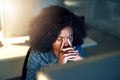 Shes on the late shift... again. a young businesswoman looking stressed out while working late in an office. Royalty Free Stock Photo